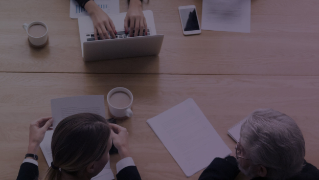 Overhead view of people working at a desk